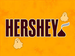 Hershey in brown text with small orange ghosts and a small Hershey chocolate