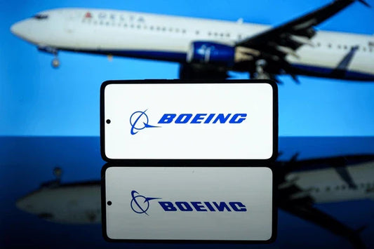 Plane in background with phone in centre with Boeing written on it.